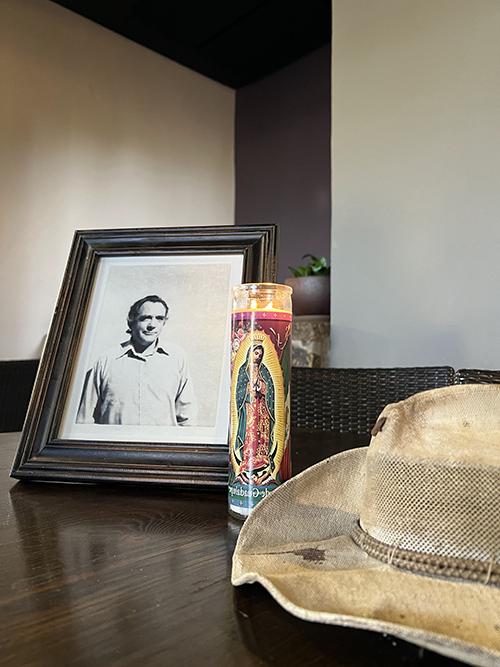 An older photo of Merv Larson is displayed with his brimmed hat in the Ocotillo Café